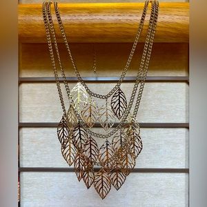 Beautiful vintage gold tone new with tags, three chain leaf necklace